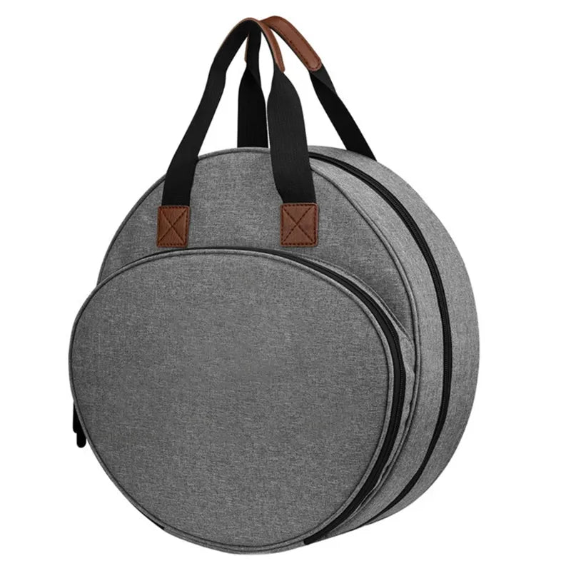 Grey round embroidery organizer bag with carry handles, shown closed